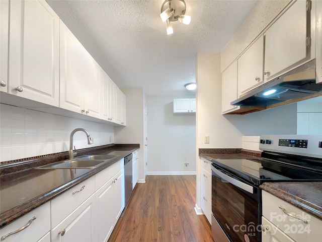 kitchen featuring appliances with stainless steel finishes, dark hardwood / wood-style floors, tasteful backsplash, white cabinets, and sink