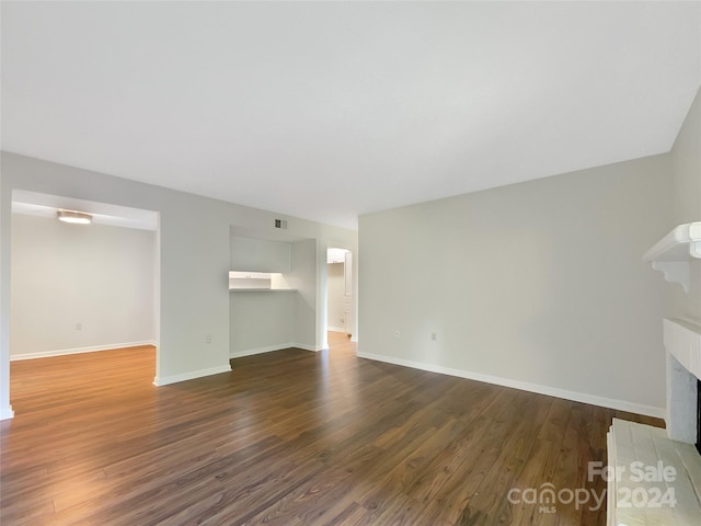 empty room featuring dark hardwood / wood-style flooring and a fireplace