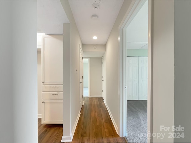 hall with hardwood / wood-style floors