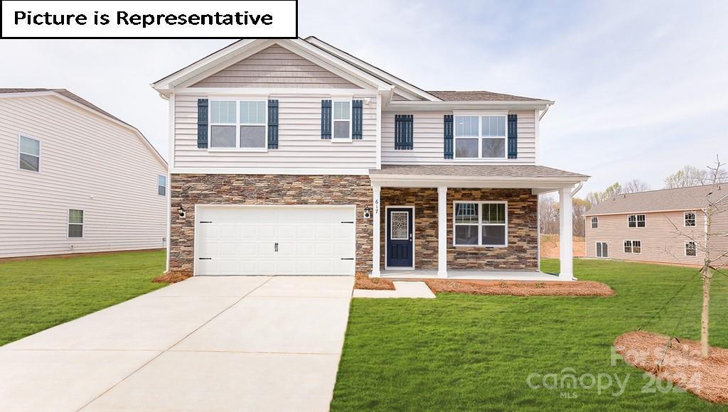 craftsman inspired home with a porch, stone siding, a front yard, and driveway