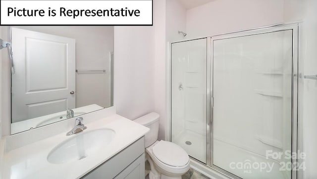 bathroom featuring walk in shower, vanity, and toilet