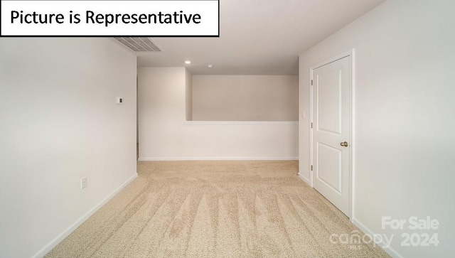 empty room featuring light colored carpet