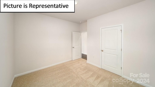 unfurnished bedroom with light colored carpet