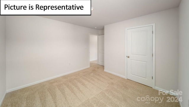 unfurnished bedroom featuring light carpet