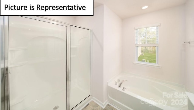 bathroom with shower with separate bathtub