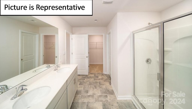 bathroom featuring vanity and an enclosed shower