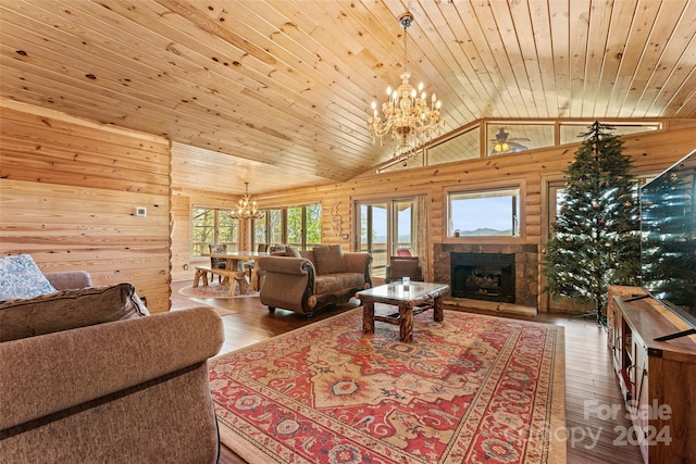 living room featuring vaulted ceiling, hardwood / wood-style flooring, wood ceiling, a fireplace, and a chandelier