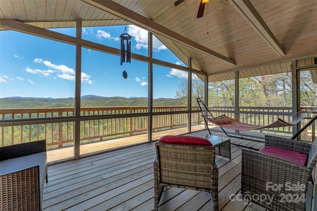 sunroom with wood ceiling, ceiling fan, and vaulted ceiling with beams