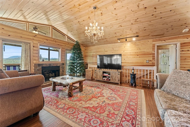 living room featuring high vaulted ceiling, wood-type flooring, wood ceiling, a fireplace, and a chandelier