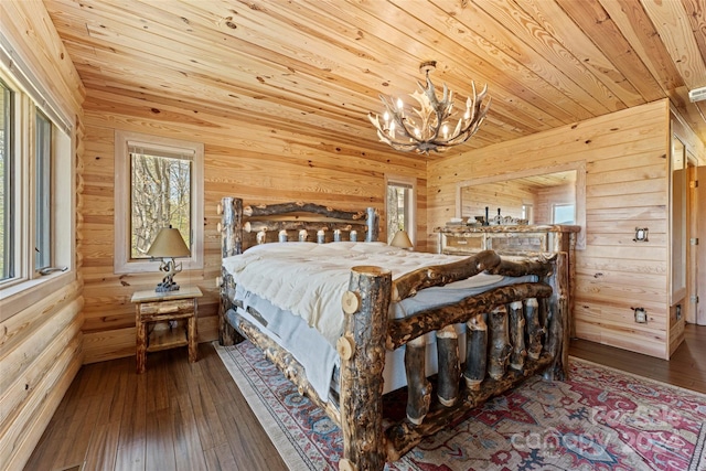 bedroom featuring wood ceiling, hardwood / wood-style floors, and a chandelier