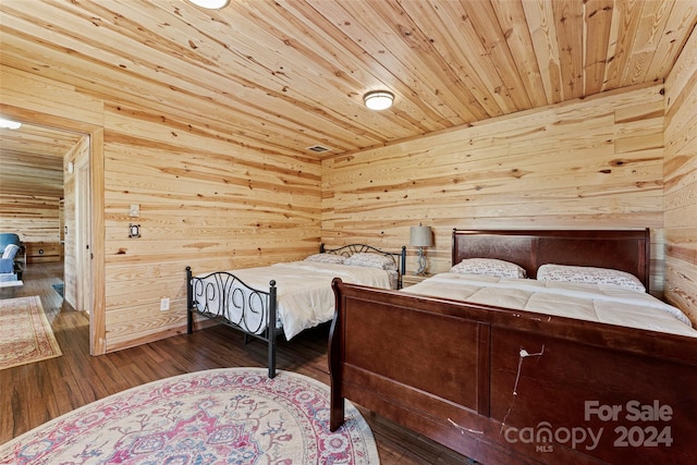 bedroom with hardwood / wood-style flooring, wooden walls, and wood ceiling