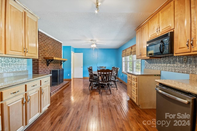 kitchen with stainless steel dishwasher, dark hardwood / wood-style flooring, ceiling fan, and a textured ceiling