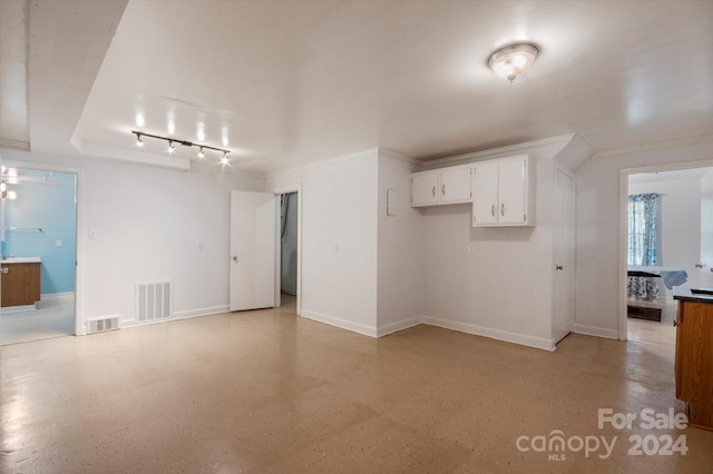 unfurnished living room featuring track lighting