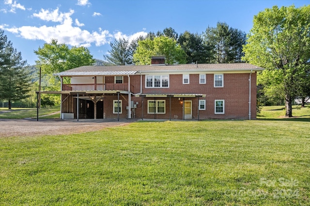 rear view of property featuring a lawn