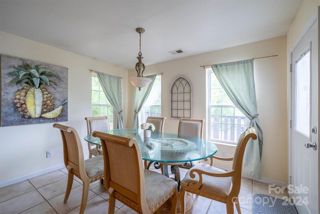 dining area with plenty of natural light and light tile floors