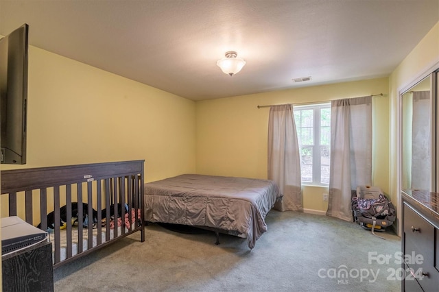 carpeted bedroom with a closet