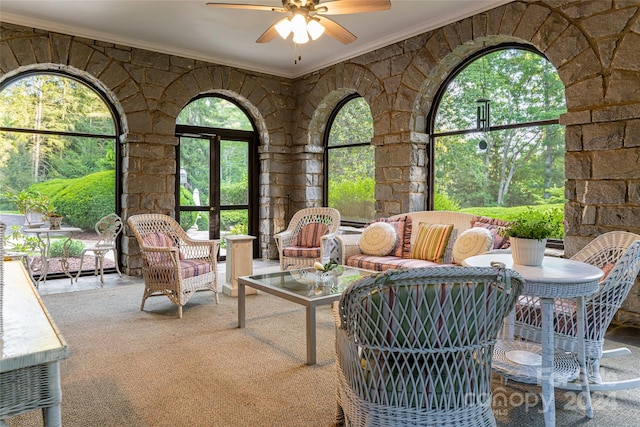 sunroom / solarium featuring ceiling fan