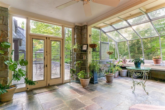 unfurnished sunroom featuring ceiling fan