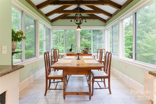 sunroom / solarium with vaulted ceiling with beams