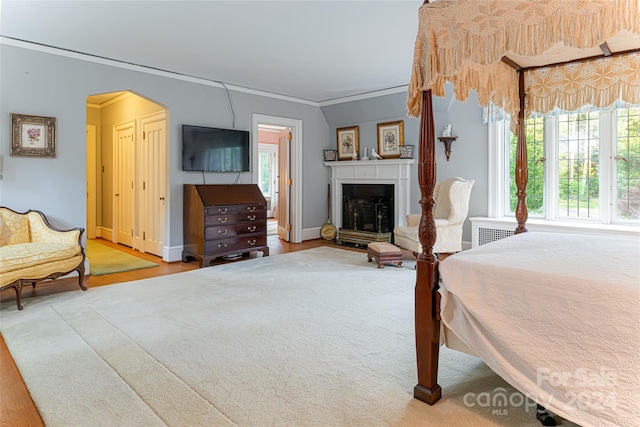 bedroom featuring light wood-type flooring and crown molding