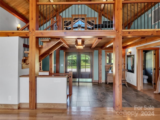 doorway with hardwood / wood-style floors, vaulted ceiling with beams, wood ceiling, and french doors