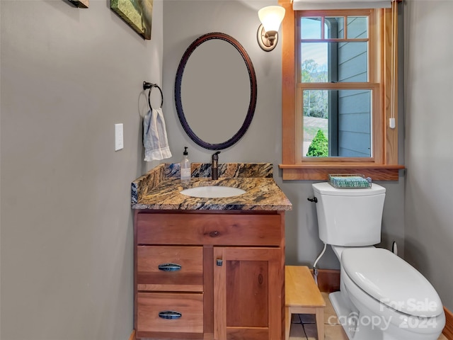 bathroom with tile patterned floors, vanity, and toilet