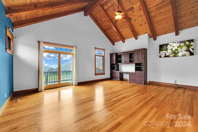 unfurnished living room with ceiling fan, light hardwood / wood-style flooring, beamed ceiling, high vaulted ceiling, and built in desk