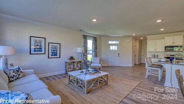 living room with hardwood / wood-style floors and ornamental molding