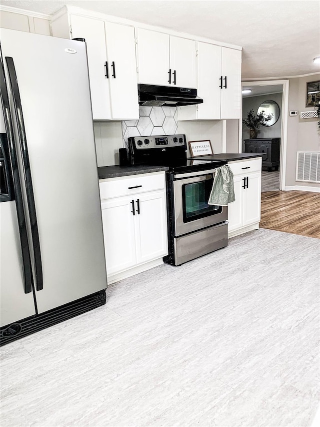 kitchen with appliances with stainless steel finishes, tasteful backsplash, light wood-type flooring, and white cabinetry