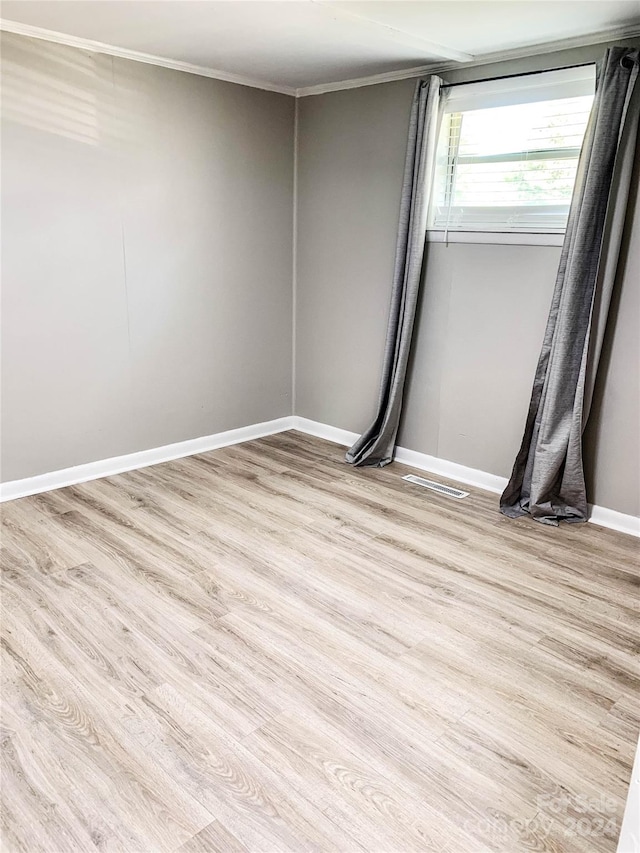 unfurnished room with light wood-type flooring