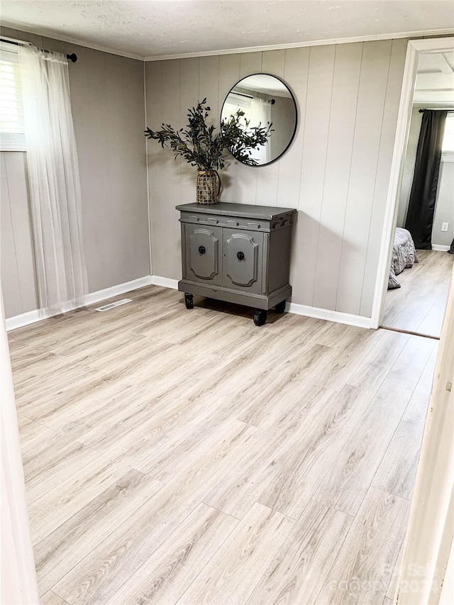 interior space featuring light wood-type flooring and a textured ceiling