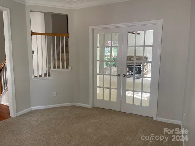 doorway to outside featuring carpet flooring, crown molding, and french doors