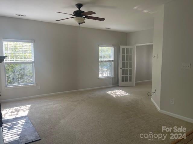 carpeted empty room with ceiling fan