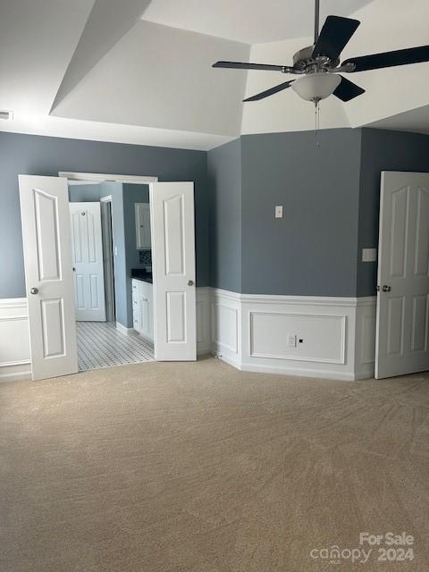 carpeted spare room with ceiling fan