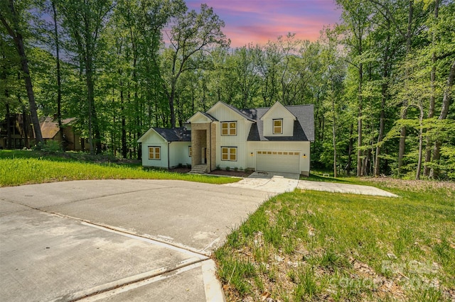 view of front of house featuring a yard and a garage