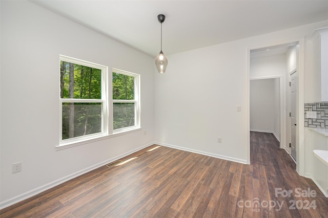 empty room with dark hardwood / wood-style flooring