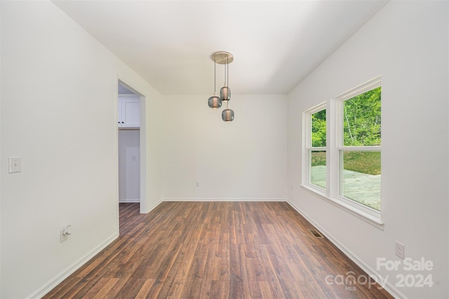 empty room featuring dark hardwood / wood-style flooring