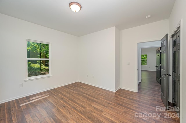 empty room with dark hardwood / wood-style floors