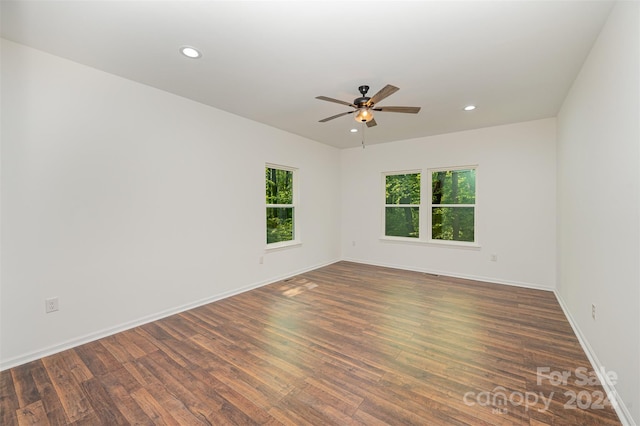 spare room with ceiling fan and dark wood-type flooring