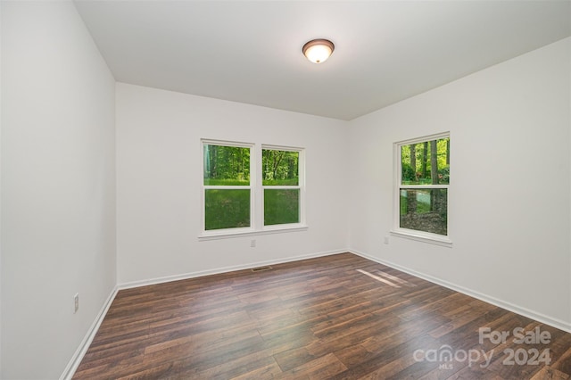 unfurnished room with dark hardwood / wood-style floors