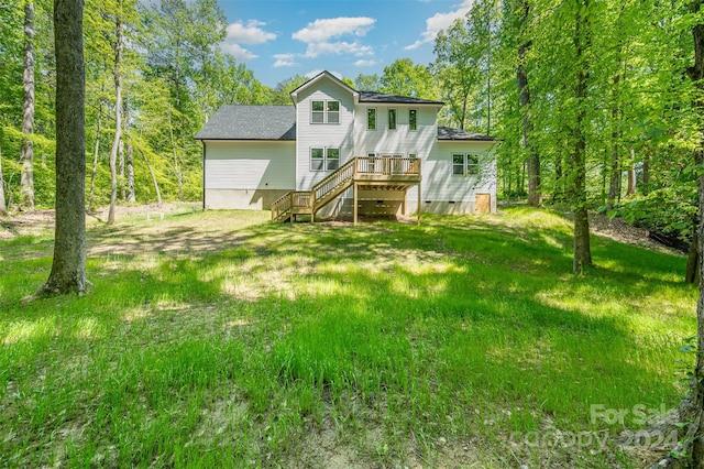 rear view of property with a deck and a yard