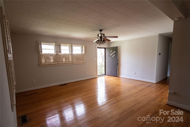 spare room with wood-type flooring and ceiling fan