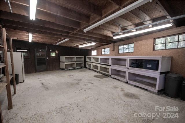 basement with white refrigerator