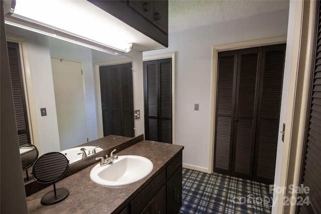 bathroom featuring tile flooring and vanity