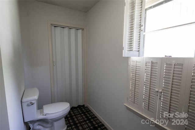 bathroom featuring tile floors and toilet