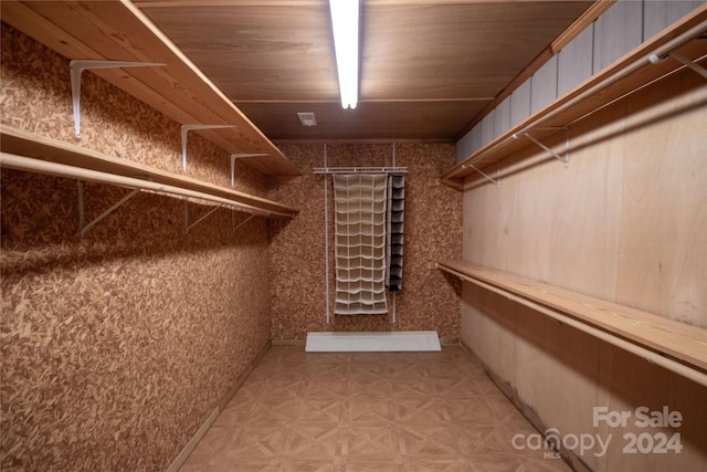 walk in closet featuring light parquet flooring