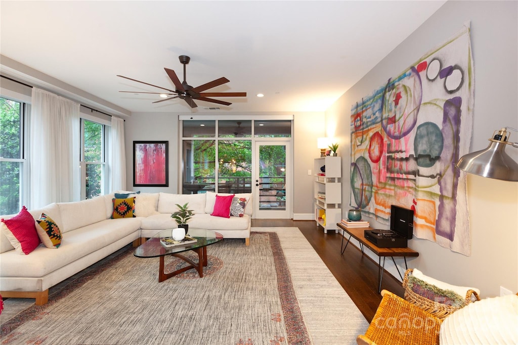 living room featuring hardwood / wood-style floors and ceiling fan