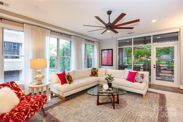 living room featuring wood-type flooring and ceiling fan