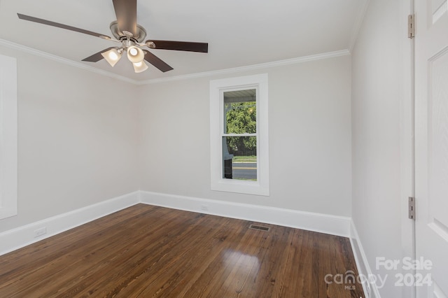 spare room with ornamental molding, dark wood-type flooring, and ceiling fan