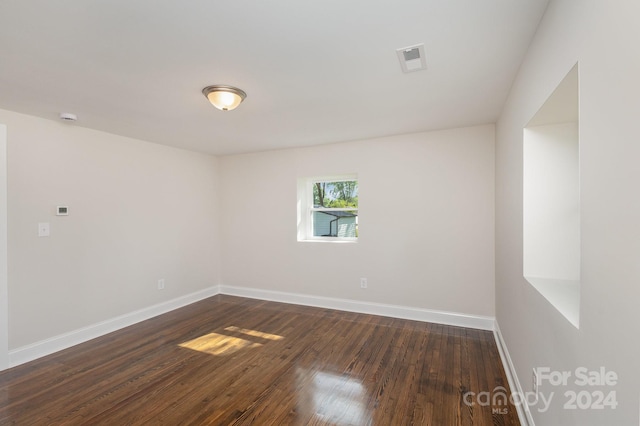 spare room with hardwood / wood-style floors